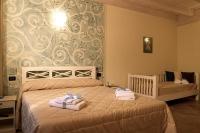 Postel nebo postele na pokoji v ubytování Agriturismo Il Barone