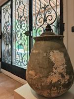 a large vase sitting in front of a window at Hostellerie Le Paradou in Lourmarin