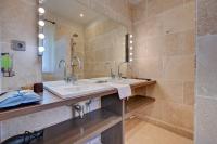 a bathroom with two sinks and a shower at Hostellerie Le Paradou in Lourmarin