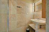 a bathroom with a sink and a shower at Hostellerie Le Paradou in Lourmarin