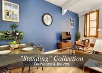 a living room with a blue wall with a clock at Nestor&amp;Jeeves - DESIGN VIEUX NICE - Old Town - Close sea in Nice