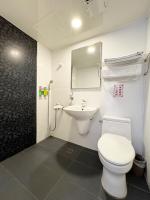 a bathroom with a white toilet and a sink at Ai Lai Fashion Hotel in Taichung