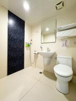 a bathroom with a toilet and a sink at Ai Lai Fashion Hotel in Taichung