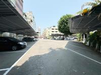 an empty parking lot with cars parked under an overpass at Ai Lai Fashion Hotel in Taichung
