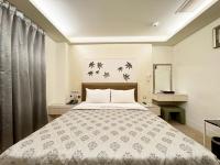 a bedroom with a large bed in a room at Ai Lai Fashion Hotel in Taichung