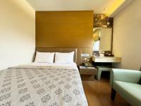 a hotel room with a bed and a sink at Ai Lai Fashion Hotel in Taichung