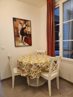 a dining room with a table and two chairs at Rue François Miron in Paris