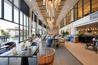 a restaurant with tables and chairs and a cafeteria at Emerald Ho Tram Resort in Ho Tram