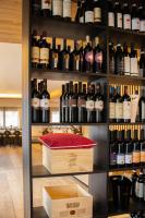 a shelf full of bottles of wine in a store at Chalet Cridola Dolomiti Experience in Lorenzago