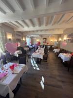 Un restaurante con mesas y sillas con globos rosas. en Logis Hôtel Restaurant La Vieille Auberge, Art and Gallery, en Souillac