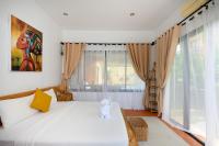 Postel nebo postele na pokoji v ubytování The Orange Villa Near Beach 海灘附近的家庭別墅