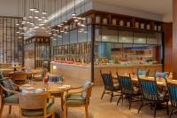 a restaurant with tables and chairs and a counter at ITC Ratnadipa, a Luxury Collection Hotel, Colombo in Colombo