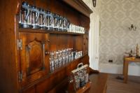 eine Holzwand mit vielen Glasflaschen darauf in der Unterkunft The Rectory Lacock - Boutique Bed and Breakfast in Lacock