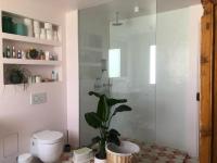 a bathroom with a toilet and a plant in it at Maison aux portes de Paris in Pantin
