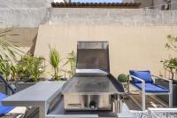 a grill sitting on top of a table on a patio at Cannes NG - Appartement à 10 mn du Palais des Festivals in Cannes