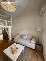 a living room with a couch and a table at Appartement + terrasse à 5min à pied de la mer et du Vallon des auffes in Marseille