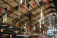 a building with flags hanging from the ceiling at ALFRED HOTELS Les Halles - Ex Hotel Anjou in Biarritz