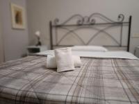 a bed with two towels sitting on top of it at 6 Keys in Pisa