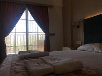 A bed or beds in a room at Hamle Hotel