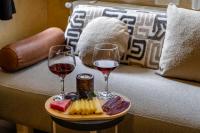 two glasses of wine and cheese on a tray on a couch at Taksim Terrace Hotel in Istanbul