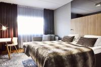 a bedroom with a large bed and a couch at Original Sokos Hotel Vaakuna Rovaniemi in Rovaniemi