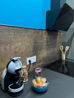 a kitchen counter with a coffee maker and a bowl of food at La nuit de rêve Spa privatif Jaccuzi Sauna suite 1 in Crouy