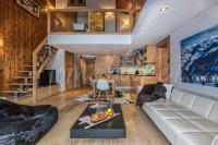 a living room with a couch and a staircase at Yupik in Megève