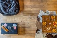 a table with food and a bag on a wooden floor at Yupik in Megève