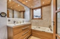 a bathroom with a sink and a tub at Yupik in Megève