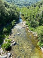 an aerial view of a river with rocks and trees at A PIAZZOLA in Petreto-Bicchisano