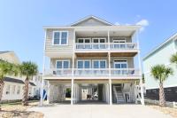 una casa con palmeras delante en Anchor Down Luxury Ocean View Beach House w Pool, en Myrtle Beach