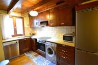 a kitchen with a refrigerator and a dishwasher at Duplex el Pla de la Tour in Latour-de-Carol