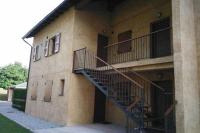 a building with a staircase on the side of it at Duplex el Pla de la Tour in Latour-de-Carol