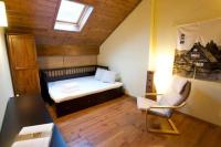 a small bedroom with a bed and a chair at Duplex el Pla de la Tour in Latour-de-Carol