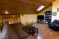 a living room with a couch and a tv at Duplex el Pla de la Tour in Latour-de-Carol