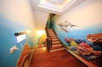 a room with a dolphin and an aquarium on the wall at Haoho in Xiaoliuqiu