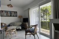 a living room with a sliding glass door to a patio at Studio with balcony - 2 min beach and AquaBaule in La Baule