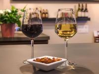 two glasses of wine and a bowl of food on a table at greet Hotel Belleville en Beaujolais A6 in Belleville-sur-Saône