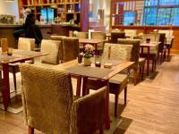 a dining room with wooden tables and chairs at Aspria Hamburg Uhlenhorst Sport & Spa in Hamburg