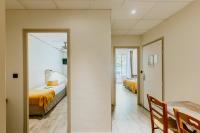 a bedroom with two beds and a mirror at Hôtel L&#39;Iroko The Originals City in Aix-les-Bains
