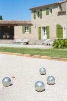 four silver balls on the ground in front of a house at La Bastide Des As in Gordes
