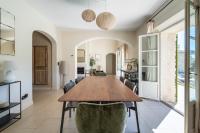 a dining room with a wooden table and chairs at La Bastide Des As in Gordes