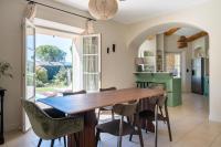 a kitchen and dining room with a wooden table and chairs at La Bastide Des As in Gordes