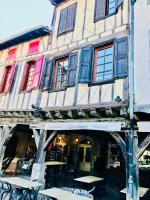 a building with tables and chairs in front of it at No 25 superbe apartment plein centre calme ,Netflix in Mirepoix