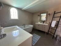 a bathroom with a tub and a sink and a bath tub at Central Valbonne Villa in Valbonne