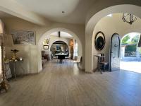a living room with an archway and a dining room at Central Valbonne Villa in Valbonne