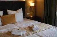 a hotel room with a bed with towels on it at PARKHOTEL - Rosarium in Uetersen