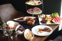 a wooden table with plates of food on it at PARKHOTEL - Rosarium in Uetersen