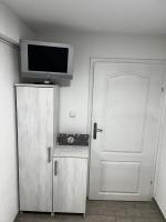 a room with a door and a television on a wall at Hostel Tuzla in Tuzla