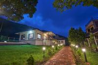 a house with lights on a lawn at night at CHAITAL VILLA in Trimbak